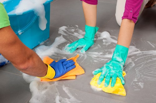 Local carpet cleaning specialist inspecting carpet fibers in New Malden